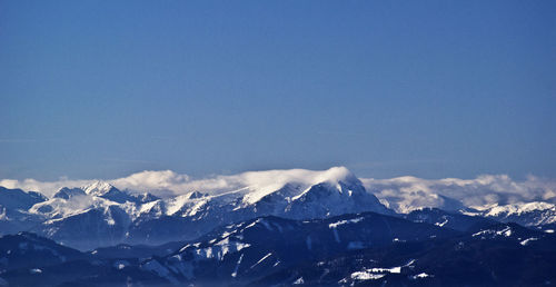 Snowcapped mountains against blue sky