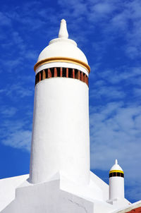 Low angle view of lighthouse against blue sky