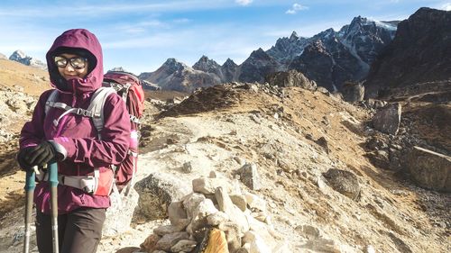 Portrait of backpacker standing on mountain