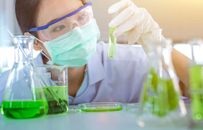 Close-up of female scientist experimenting in laboratory