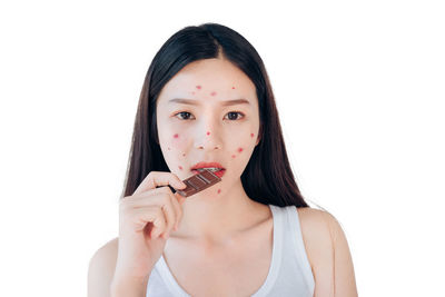 Portrait of a beautiful young woman over white background