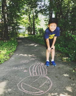 Full length portrait of boy standing on footpath