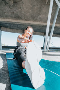 Portrait of young woman sitting on slide