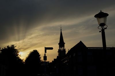 Low angle view of silhouette building against sky at sunset