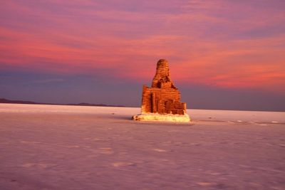 Traditional building against sky during sunset