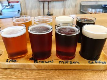 Close-up of beer glasses on table