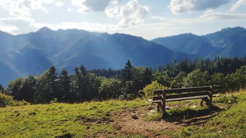 Scenic view of trees and mountains against sky