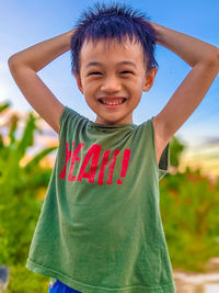 Portrait of smiling boy standing outdoors