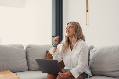 Young woman using laptop at home