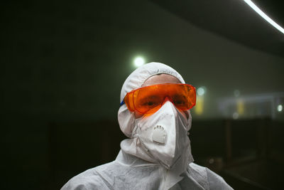 Portrait of man wearing protective goggles in laboratory