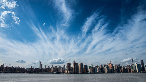 Panoramic view of sea and buildings against sky