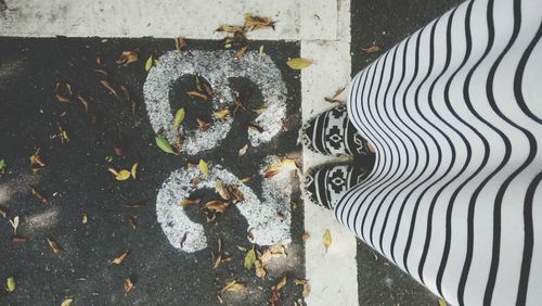 Low section of woman standing on ground