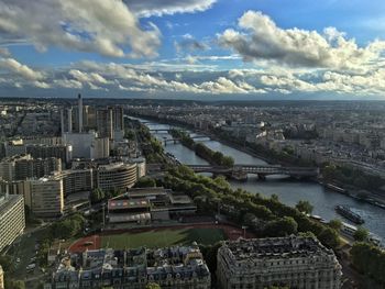 Aerial view of city against cloudy sky