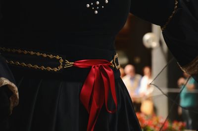 Midsection of woman wearing black dress