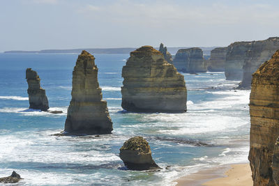 Rock formations in sea against sky