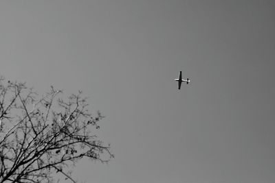 Low angle view of airplane flying against clear sky