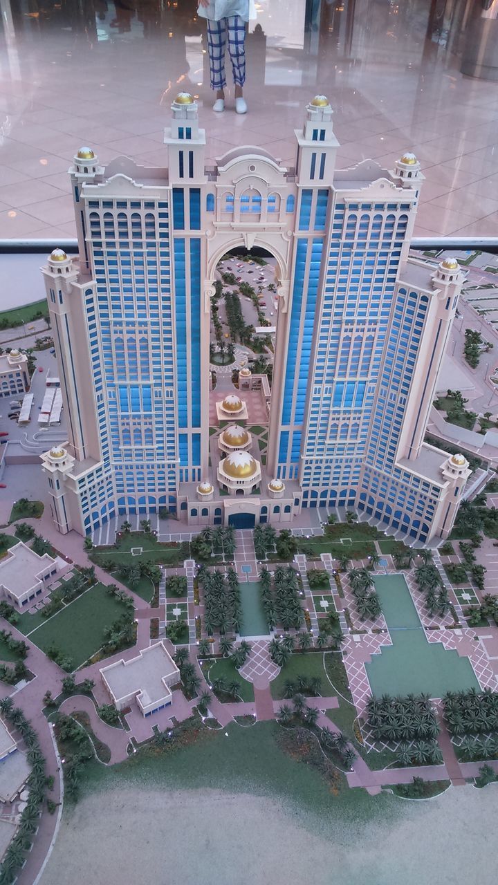 HIGH ANGLE VIEW OF SWIMMING POOL BY BUILT STRUCTURES