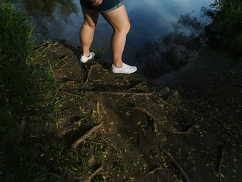 Low section of man standing on ground