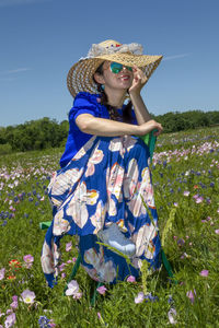 Full length of woman wearing hat standing on field