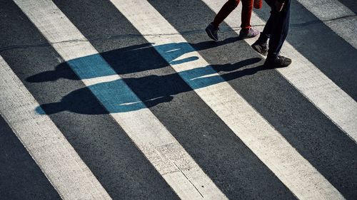 Low section of woman walking on street