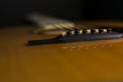 Close-up of guitar on table