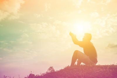 Man and woman against sky during sunset