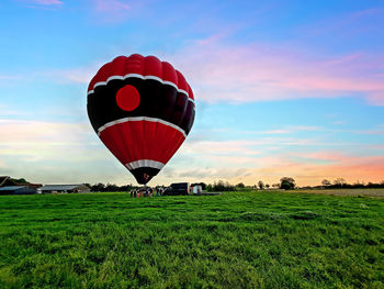 Hot air balloon ready for take off in the countryside from the netherlands at sunset
