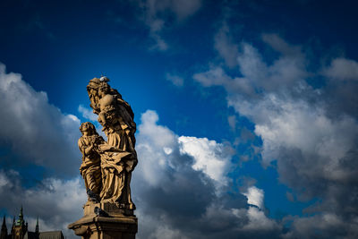 Low angle view of statue against cloudy sky