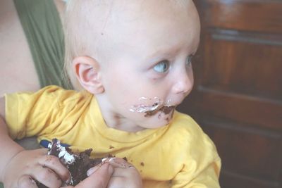 Close-up of cute baby boy eating cake