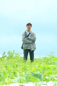 Man standing on field against sky