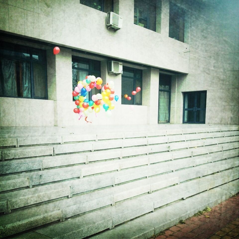 architecture, built structure, building exterior, steps, multi colored, building, window, house, railing, residential structure, residential building, day, staircase, city, steps and staircases, outdoors, no people, wall - building feature, flower, door