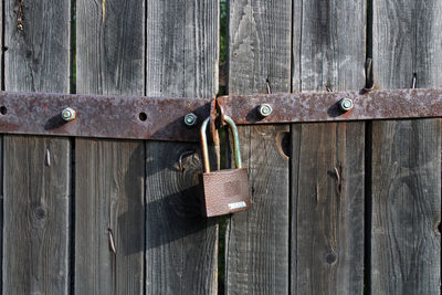 Padlock on wooden door