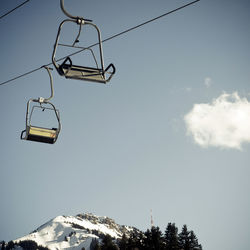 Low angle view of ski lift against sky