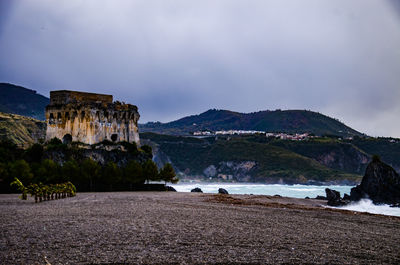 Scenic view of mountain against cloudy sky