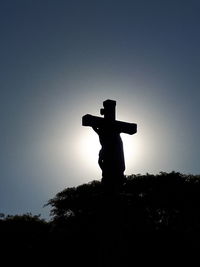 Low angle view of silhouette statue against sky