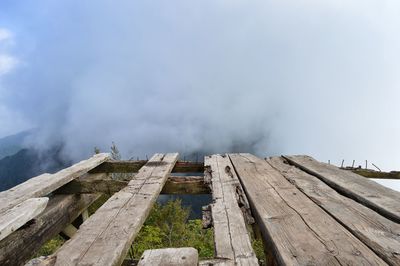 Low angle view of wooden mountain against sky