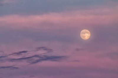 Low angle view of moon against sky at sunset