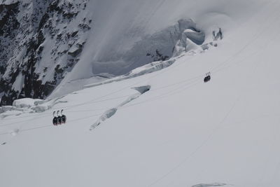 People skiing on snowcapped mountain