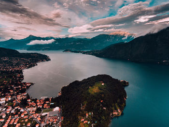 Scenic view of sea and mountains against sky