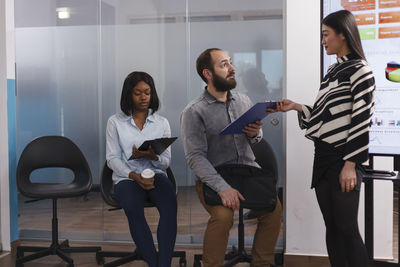 Candidates sitting on chair for interview in office