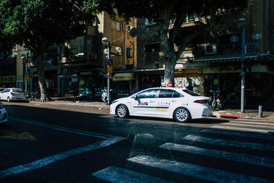 Cars on street by buildings in city