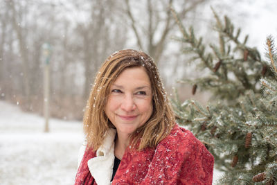 Portrait of smiling woman in snow