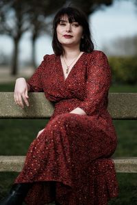 Portrait of young woman sitting outdoors