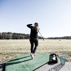 Full length of woman standing against clear sky