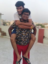 Portrait of young couple standing outdoors