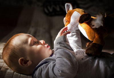 Close-up of baby boy playing with toy