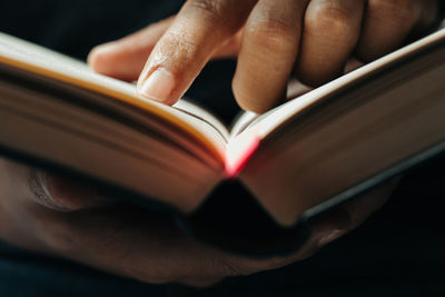 Close-up of hand holding book