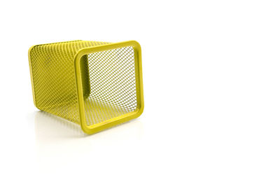 High angle view of small yellow container on white background