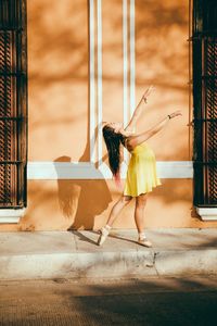 Woman standing against built structure