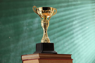 Close-up of trophy on books